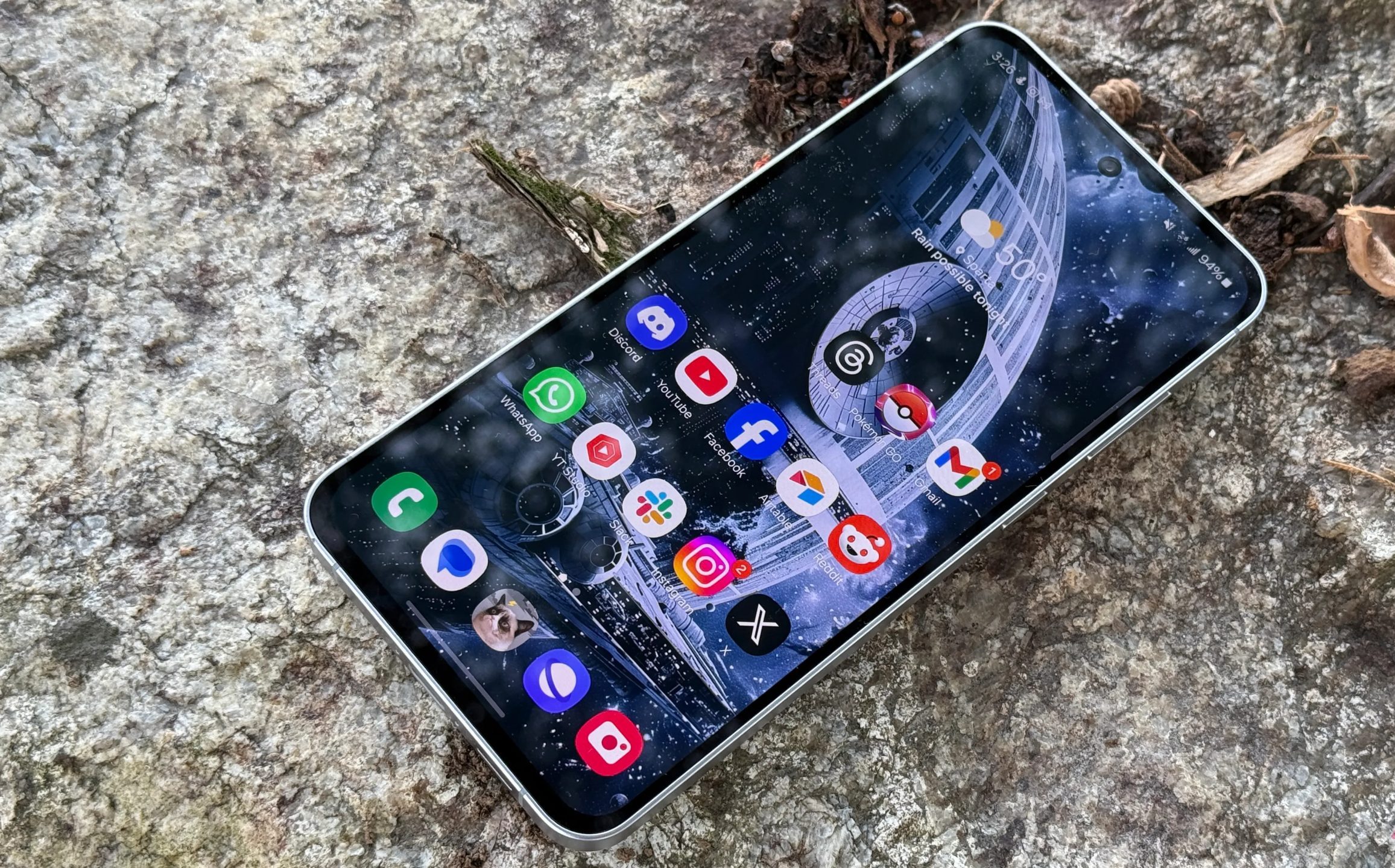 Samsung Galaxy S24 FE laying on a rock
