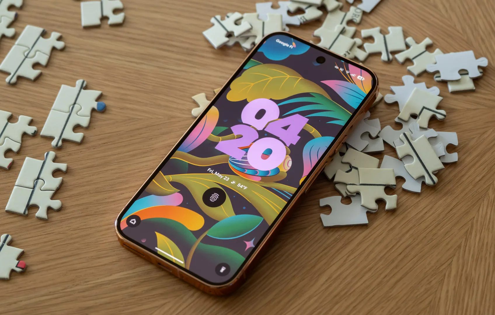 A Pixel 9 Pro sitting face-up on top of puzzle pieces.