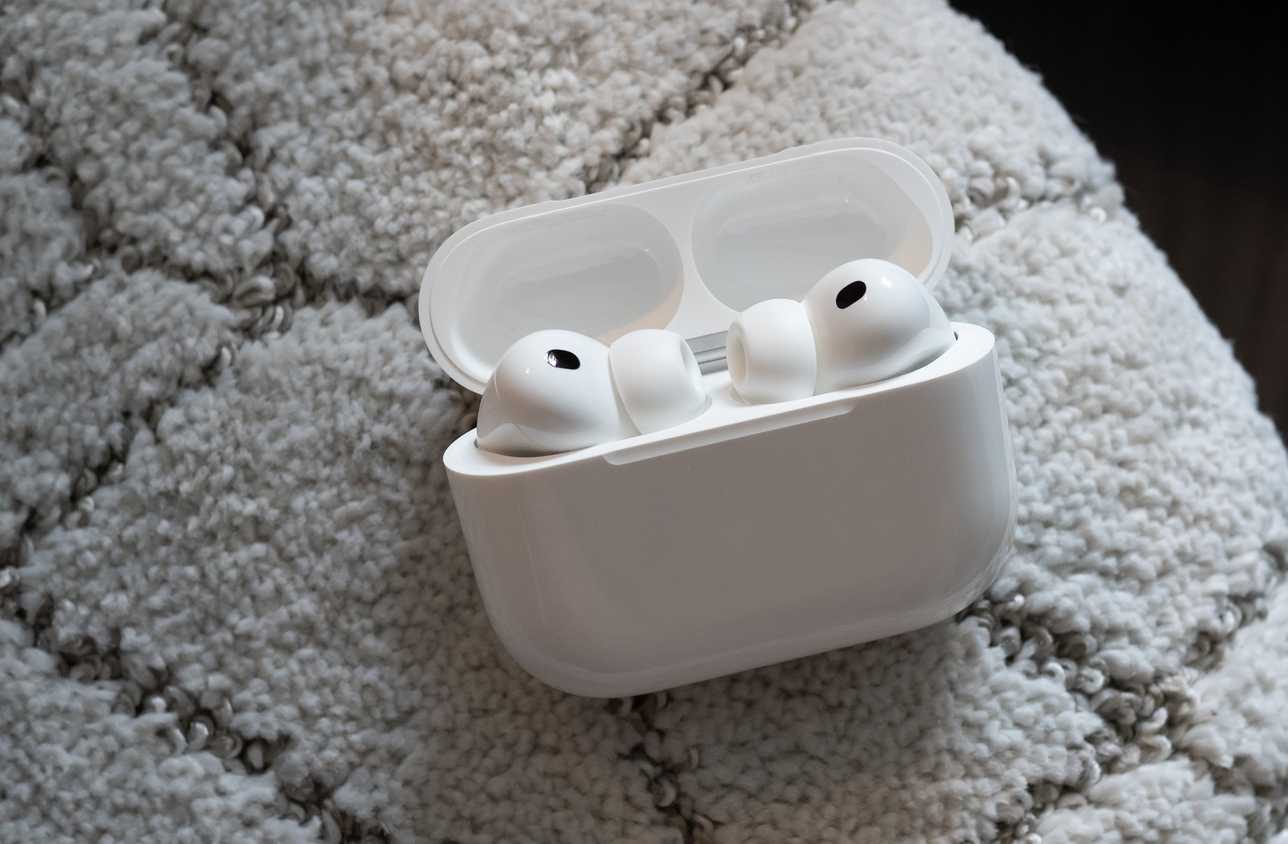The AirPods Pro 3 in a case sitting on a carpet