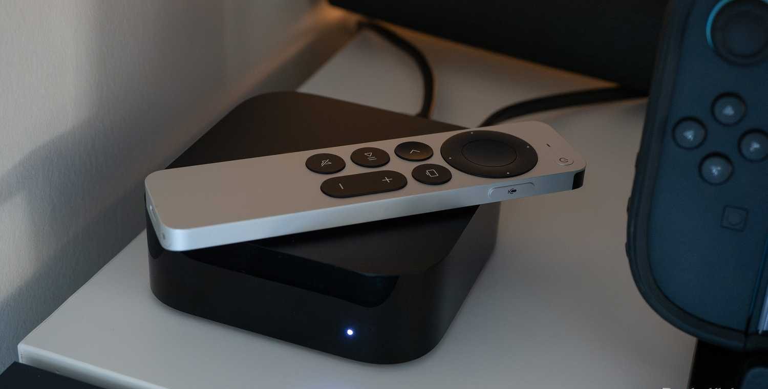 Apple TV 4K sitting on a TV shelf