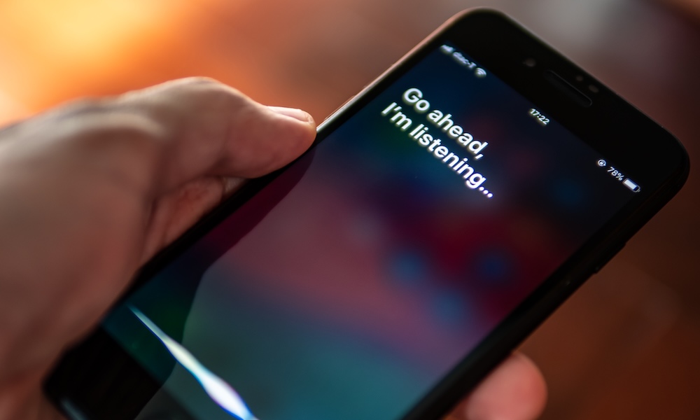 Bangkok, Thailand July 30, 2019 : Siri, Apple's voice activated digital assistant, tells iPhone user to ask her by showing the text "Go ahead, I'm listening" on the display.