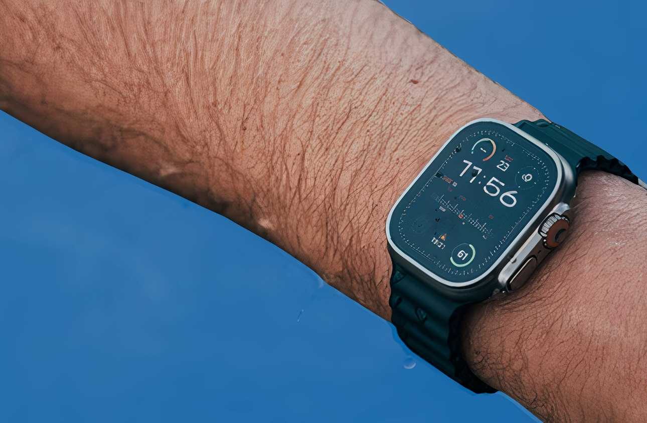 An arm wearing an Apple Watch Ultra 2 coming out of the water.