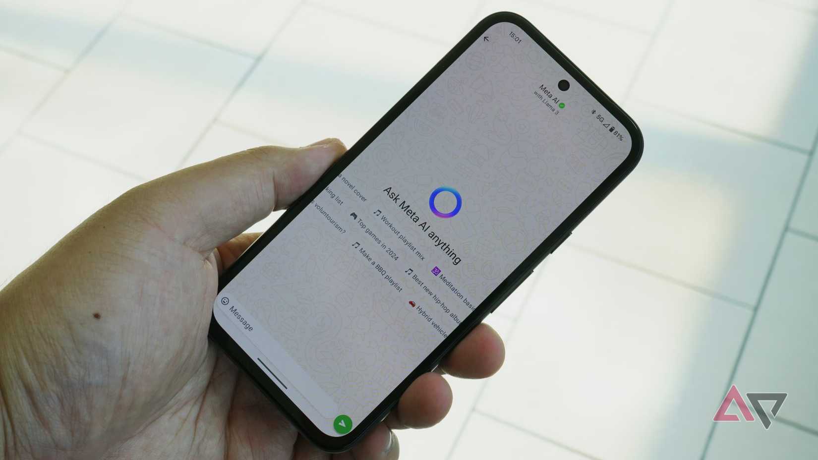 هاتف محمول في يد يعرض واجهة دردشة WhatsApp Meta AI.