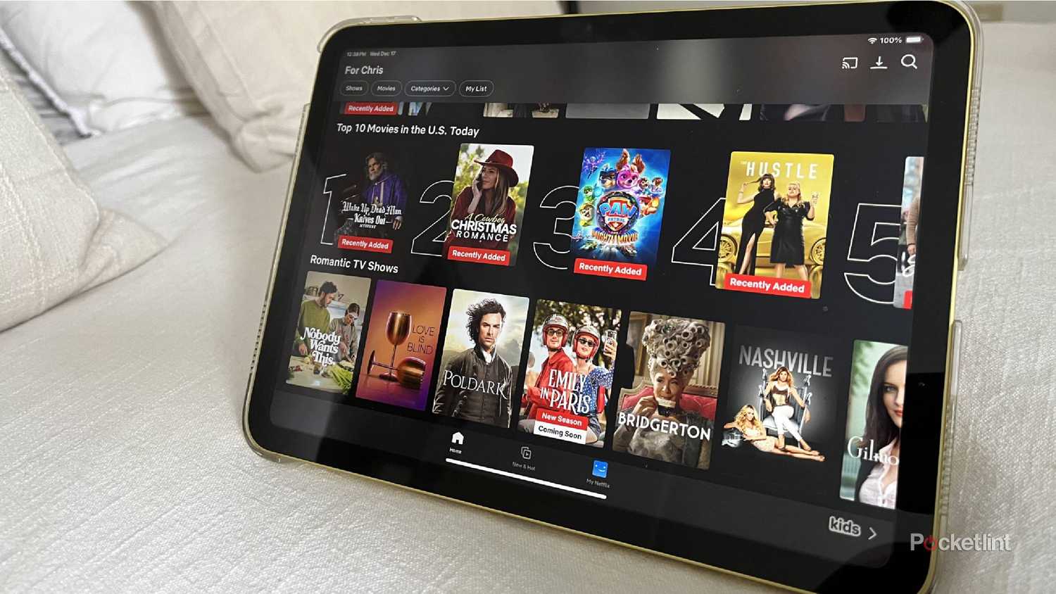 An iPad on a bed showing Netflix.