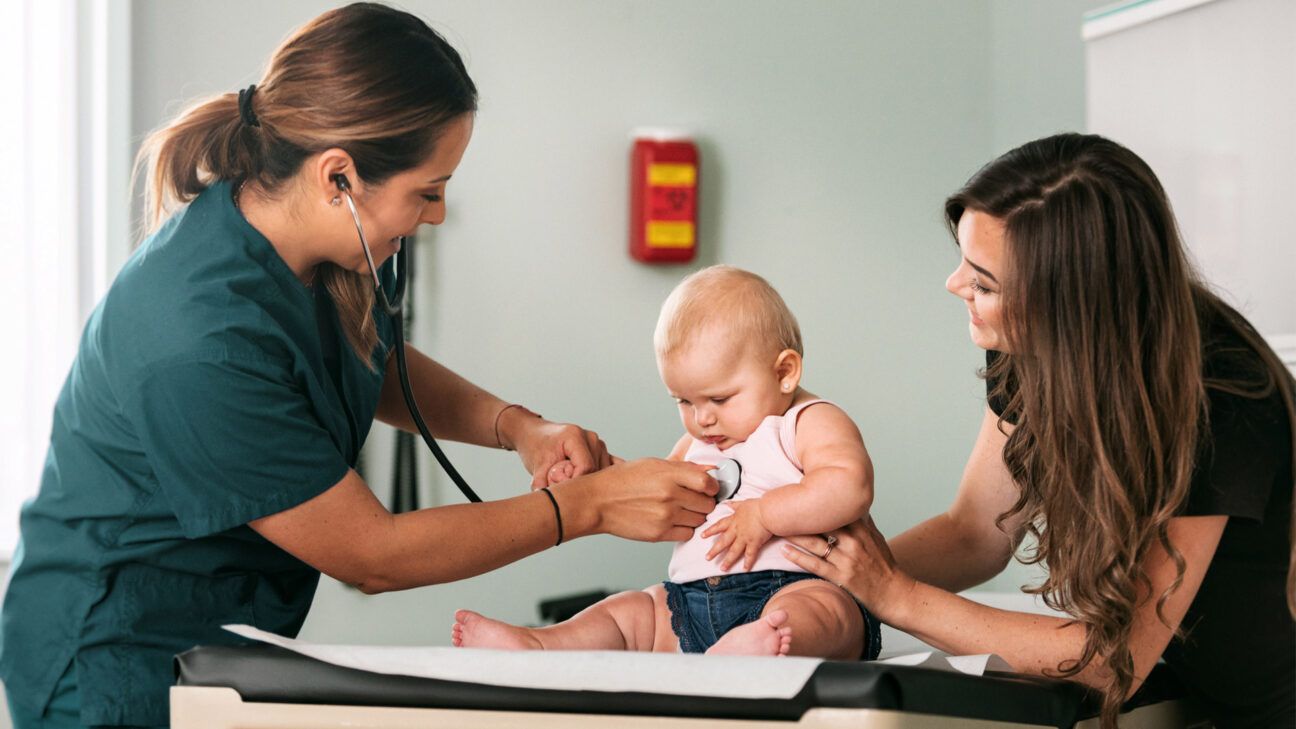 Female doctor with patient and infant