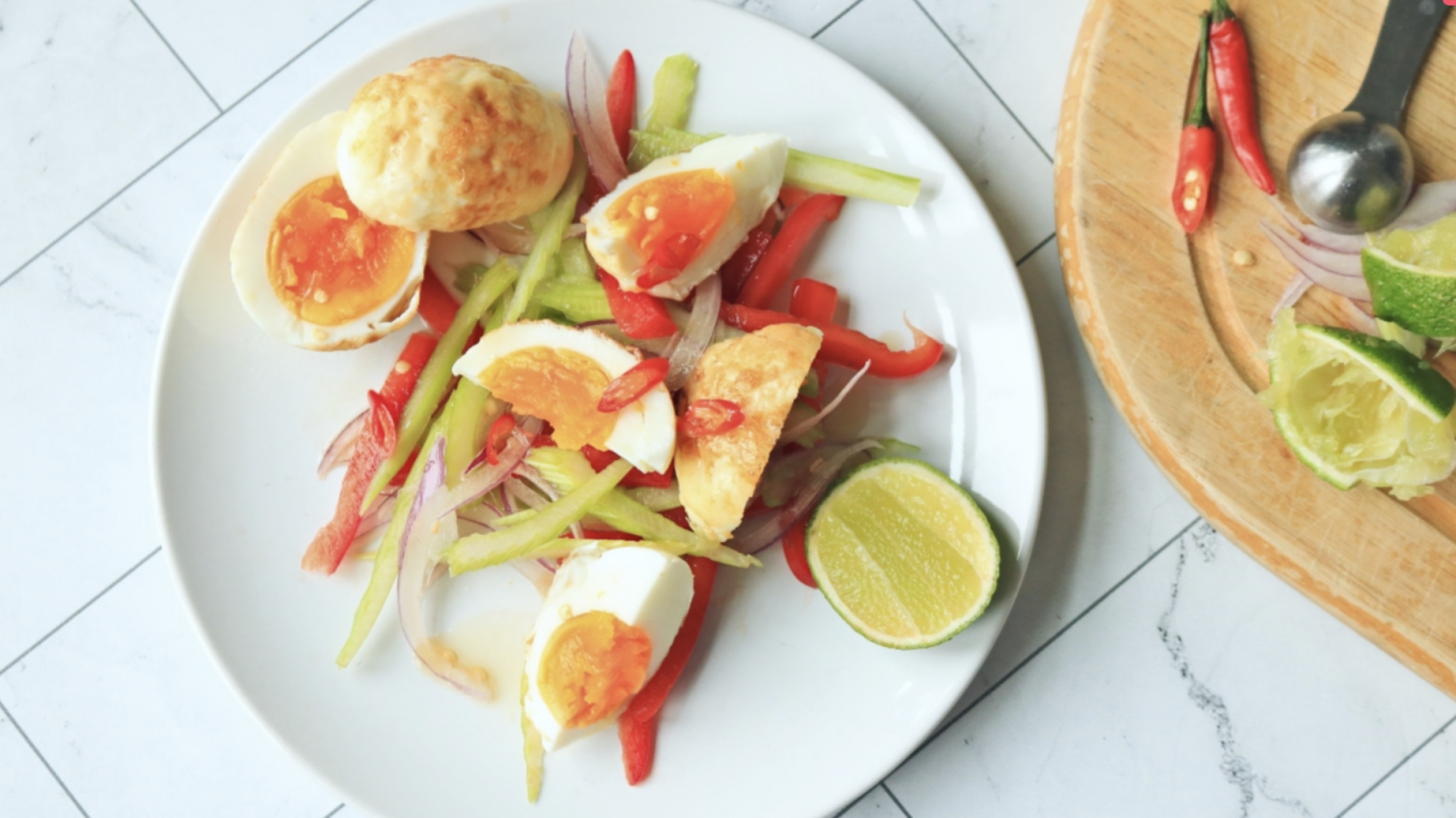 Fried hard boiled egg salad with peppers.