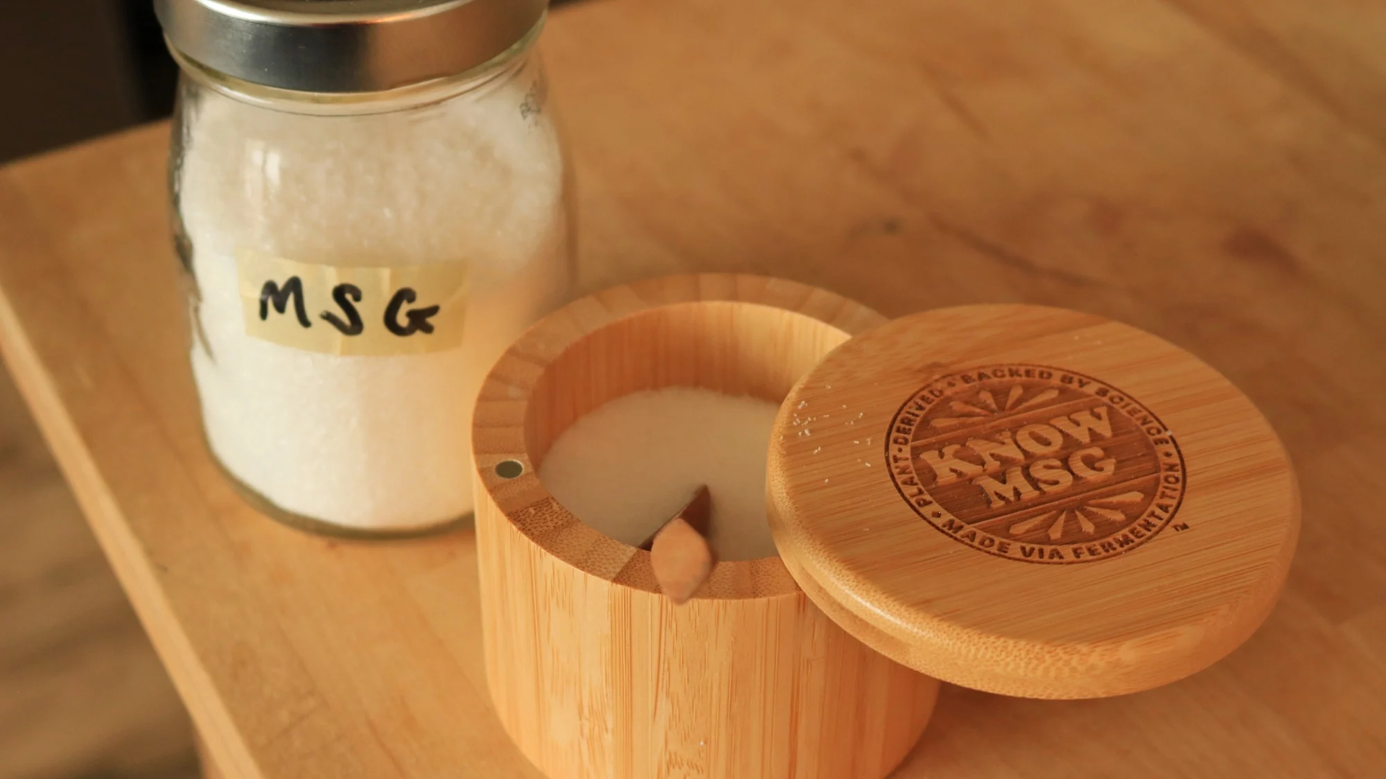 MSG in a bamboo keeper next to a jar of MSG.