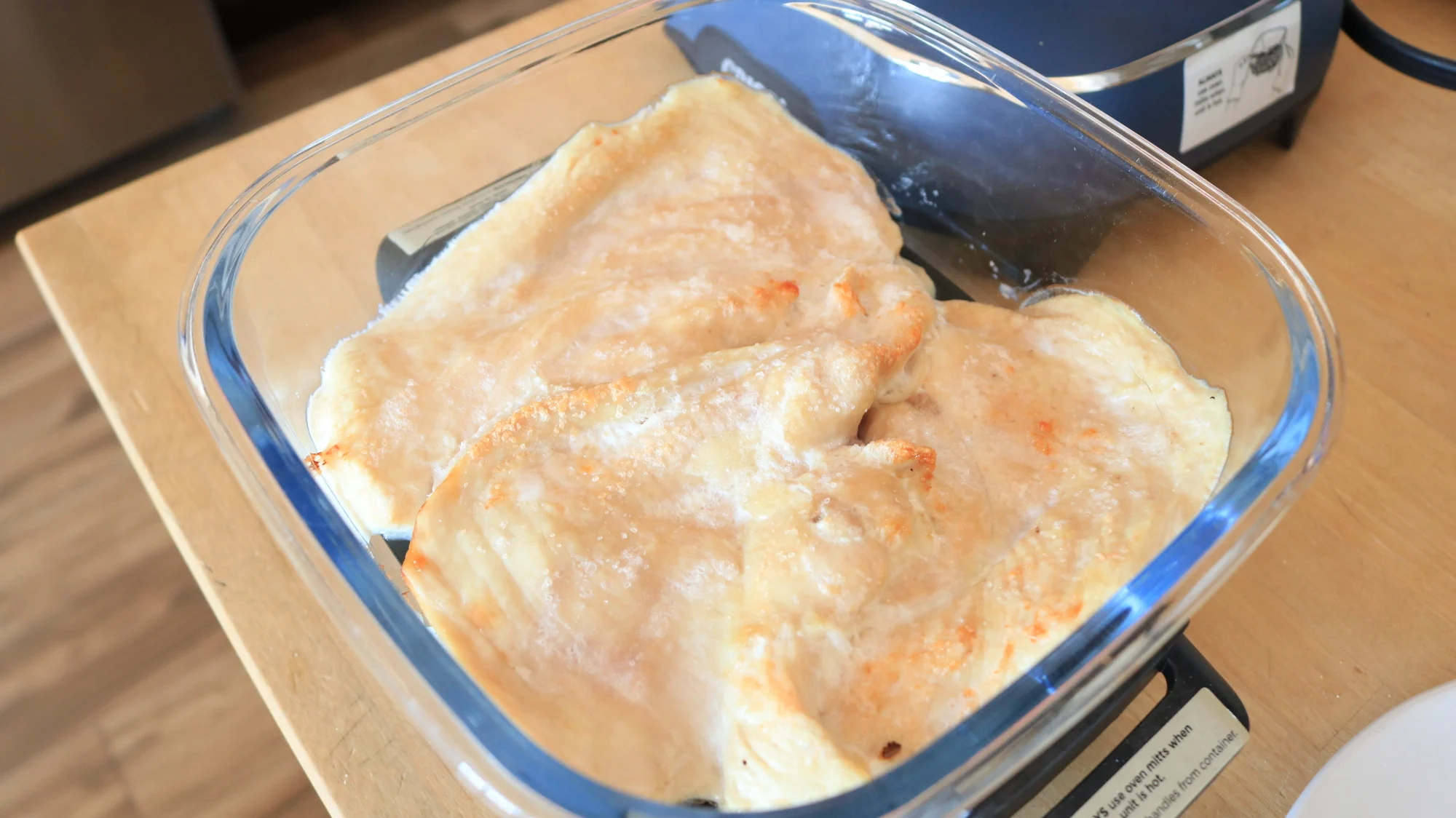 Cooked chicken breast slices in the Ninja Crispi.