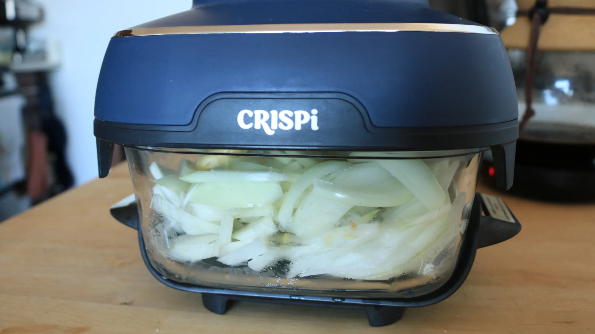 Onion slices cooking in the Ninja Crispi container.