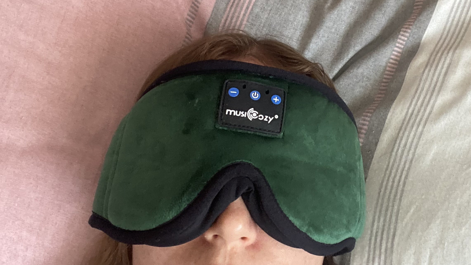 A closeup of the MUSICOZY Headphone sleep mask on our tester. The mask covers most of the top half of the face.